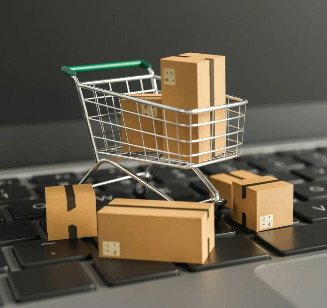 Parcels in a shopping cart on a laptop keyboard — Amazon orders